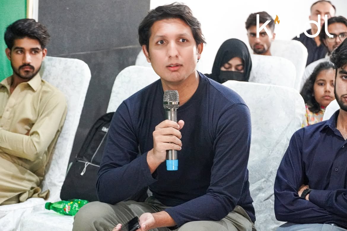 Attendee speaking with a microphone during Q&A
